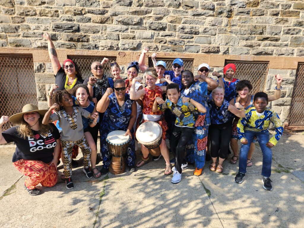 Bele Bele and sons pose for a group photo outdoors in Baltimore