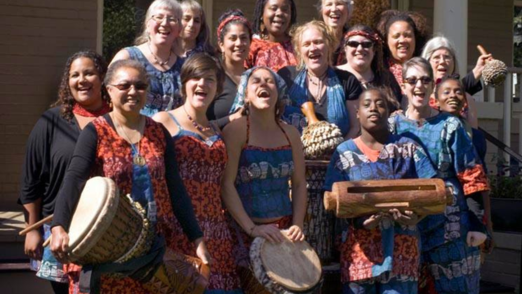 Bele Bele Rhythm Collective members smile and pose for a happy group photo